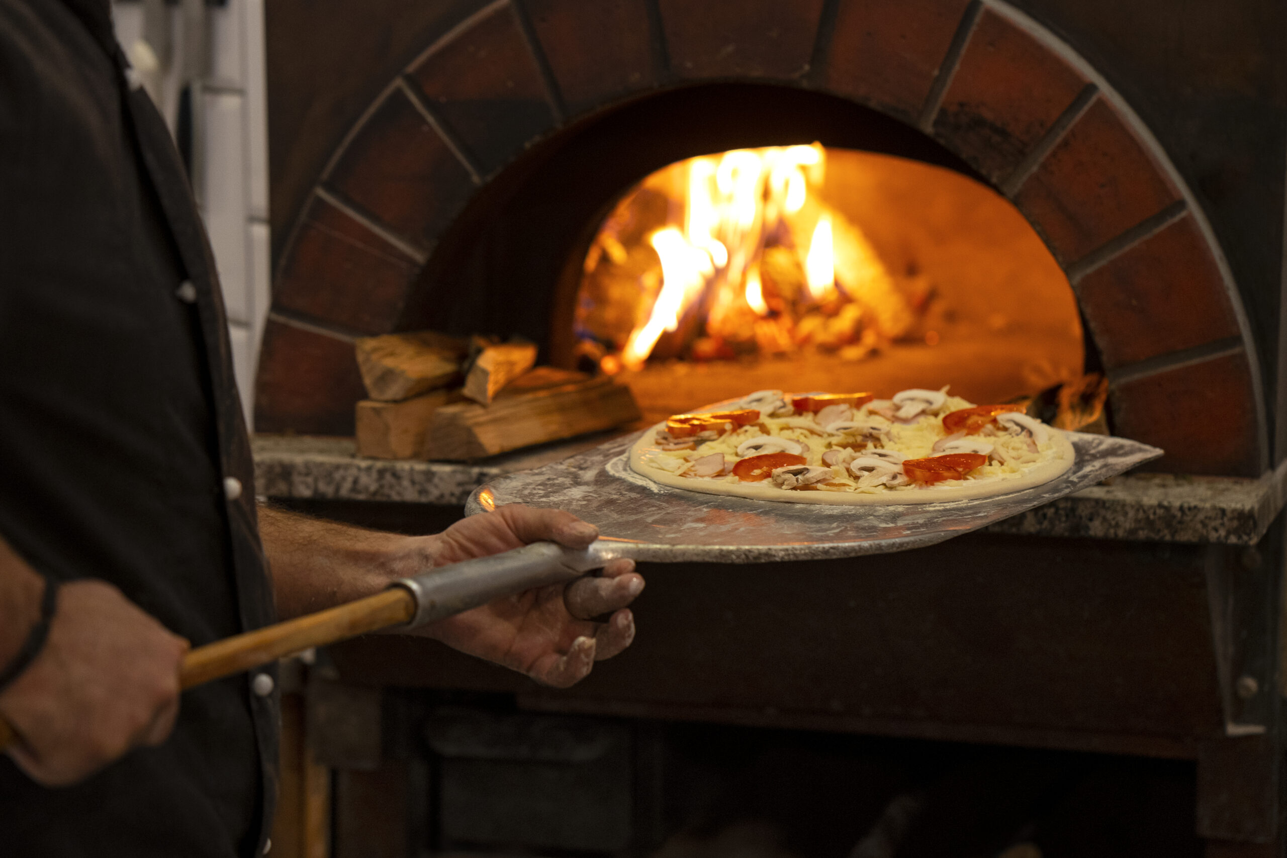 side-view-chef-baking-delicious-pizza